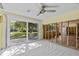 Unfinished living room featuring tile flooring and sliding doors overlooking the backyard at 6090 Waverly Rd, Weeki Wachee, FL 34607