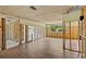 Unfinished living room featuring wood-look tile flooring and exposed framing at 6090 Waverly Rd, Weeki Wachee, FL 34607