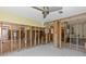 Unfinished living room featuring tile flooring, ceiling fan, and exposed framing at 6090 Waverly Rd, Weeki Wachee, FL 34607