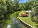 Lovely riverfront home with a covered boat lift on the property and beautiful river at 6090 Waverly Rd, Weeki Wachee, FL 34607