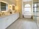This spacious bathroom is complete with a tub, shower, and dual sink vanity for maximum convenience at 6393 Pinehurst Dr, Spring Hill, FL 34606