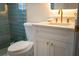 Stylish bathroom features a white vanity, gold hardware, granite countertop, and modern fixtures at 6393 Pinehurst Dr, Spring Hill, FL 34606