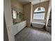 Bathroom features a soaking tub and glass block window in a modern design at 6393 Pinehurst Dr, Spring Hill, FL 34606