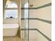 A luxurious bathtub and walk-in shower offer a relaxing experience with stylish fixtures and details at 6393 Pinehurst Dr, Spring Hill, FL 34606