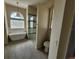 Bathroom with frameless glass shower, soaking tub, and private toilet area at 6393 Pinehurst Dr, Spring Hill, FL 34606