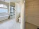 Bathroom showcases a step-in shower with a sleek glass enclosure, soaking tub, and walk-in closet at 6393 Pinehurst Dr, Spring Hill, FL 34606
