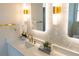 Modern bathroom featuring a vanity, illuminated mirrors, hexagon backsplash, and gold hardware at 6393 Pinehurst Dr, Spring Hill, FL 34606