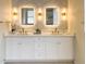 Beautifully designed bathroom with dual sinks, modern lighting, and elegant hexagonal tile backsplash at 6393 Pinehurst Dr, Spring Hill, FL 34606