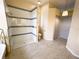 This bathroom showcases a step-in shower with a sleek glass enclosure and decorative blue tiling at 6393 Pinehurst Dr, Spring Hill, FL 34606