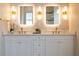 Modern bathroom featuring a double vanity, illuminated mirrors, hexagon backsplash, and white cabinets at 6393 Pinehurst Dr, Spring Hill, FL 34606