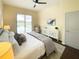 Bedroom with view of backyard pool featuring an elegant ceiling fan and gray accent pillows at 6393 Pinehurst Dr, Spring Hill, FL 34606