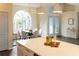 Bright dining room featuring a modern chandelier, round table, and a large arched window at 6393 Pinehurst Dr, Spring Hill, FL 34606