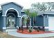 Inviting front entrance with double doors, manicured landscaping, and a circular driveway at 6393 Pinehurst Dr, Spring Hill, FL 34606