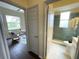 Hallway view into the office and bathroom with stylish doors and modern fixtures at 6393 Pinehurst Dr, Spring Hill, FL 34606