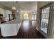 Spacious kitchen features a large island, modern pendant lighting, and wood floors that flow into the living area at 6393 Pinehurst Dr, Spring Hill, FL 34606