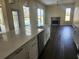 Bright kitchen with island overlooks the pool and leads into a cozy living room with a fireplace at 6393 Pinehurst Dr, Spring Hill, FL 34606