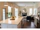 Well-appointed kitchen with stainless appliances, an island, white cabinetry, and open sightlines to the living area at 6393 Pinehurst Dr, Spring Hill, FL 34606