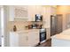 Bright kitchen with stainless steel appliances and white cabinetry at 6393 Pinehurst Dr, Spring Hill, FL 34606