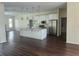 Open concept kitchen with island, stainless appliances, and modern lighting fixtures at 6393 Pinehurst Dr, Spring Hill, FL 34606