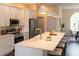 Bright kitchen island with modern pendant lighting, brass faucet, and white countertop at 6393 Pinehurst Dr, Spring Hill, FL 34606