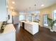 Spacious kitchen featuring a large center island, white cabinets, and stainless steel appliances at 6393 Pinehurst Dr, Spring Hill, FL 34606
