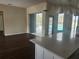 Kitchen island view to living room with sliders to screened-in pool at 6393 Pinehurst Dr, Spring Hill, FL 34606