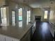 Modern kitchen island overlooking pool views and fireplace at 6393 Pinehurst Dr, Spring Hill, FL 34606