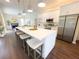 Modern kitchen with white cabinetry, stainless steel appliances, and a large center island with seating at 6393 Pinehurst Dr, Spring Hill, FL 34606