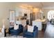 Open concept kitchen showcasing white cabinets, stainless steel appliances, and a large kitchen island at 6393 Pinehurst Dr, Spring Hill, FL 34606