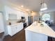 Modern kitchen featuring white cabinets, stainless steel appliances, and center island at 6393 Pinehurst Dr, Spring Hill, FL 34606