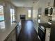 Open-concept kitchen with island flows into the living room featuring a fireplace and view of the pool at 6393 Pinehurst Dr, Spring Hill, FL 34606