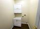Functional laundry room ready for washer and dryer hookups with bright white cabinetry at 6393 Pinehurst Dr, Spring Hill, FL 34606