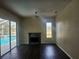 Living room with fireplace and sliding glass doors overlooking the pool at 6393 Pinehurst Dr, Spring Hill, FL 34606
