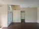 Living room featuring high ceilings, dark laminate flooring, and french door entrance at 6393 Pinehurst Dr, Spring Hill, FL 34606