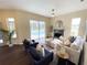Inviting living room featuring modern furnishings, fireplace, and view to backyard pool at 6393 Pinehurst Dr, Spring Hill, FL 34606