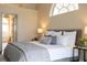 Comfortable main bedroom with a neutral color scheme and a glimpse into the modern ensuite bathroom at 6393 Pinehurst Dr, Spring Hill, FL 34606