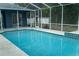 This pool is surrounded by screens and is perfect for a hot day at 6393 Pinehurst Dr, Spring Hill, FL 34606
