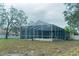 Screened pool enclosure offers outdoor living and entertaining space at 6393 Pinehurst Dr, Spring Hill, FL 34606