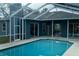 Screened-in pool and patio area with views of the home and covered outdoor space at 6393 Pinehurst Dr, Spring Hill, FL 34606