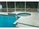 This pool has steps leading into it and a round jacuzzi on the side at 6393 Pinehurst Dr, Spring Hill, FL 34606
