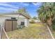 View of a quaint backyard featuring a storage shed, HVAC unit, and partial fencing at 7037 Green St, New Port Richey, FL 34652