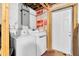 Basement laundry area featuring a washing machine, dryer, and a convenient utility sink at 7037 Green St, New Port Richey, FL 34652