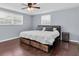 Cozy bedroom featuring a comfortable bed with storage, wood floors, and a ceiling fan for added comfort at 7037 Green St, New Port Richey, FL 34652