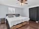 Bright bedroom features a comfortable bed, ceiling fan, and closet with black curtain, perfect for relaxation at 7037 Green St, New Port Richey, FL 34652
