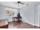 Bright bedroom showcasing a desk and an ergonomic gaming chair with natural light and hardwood floors at 7037 Green St, New Port Richey, FL 34652