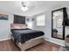 Bedroom with a stylish bed, light blue walls, window with blinds, mirror, and car decor at 7037 Green St, New Port Richey, FL 34652