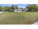Charming single-story home with a well-manicured lawn and mature trees at 7037 Green St, New Port Richey, FL 34652