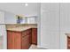 Kitchen featuring a breakfast bar with stylish granite countertops and cherry wood cabinets at 7037 Green St, New Port Richey, FL 34652