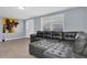 Cozy living room with a grey leather sectional and natural light from a bright window at 7037 Green St, New Port Richey, FL 34652