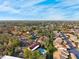 Aerial view of the neighborhood featuring a community pool, lush landscaping, and well-maintained buildings at 7650 Forest Trl # 7, Port Richey, FL 34668